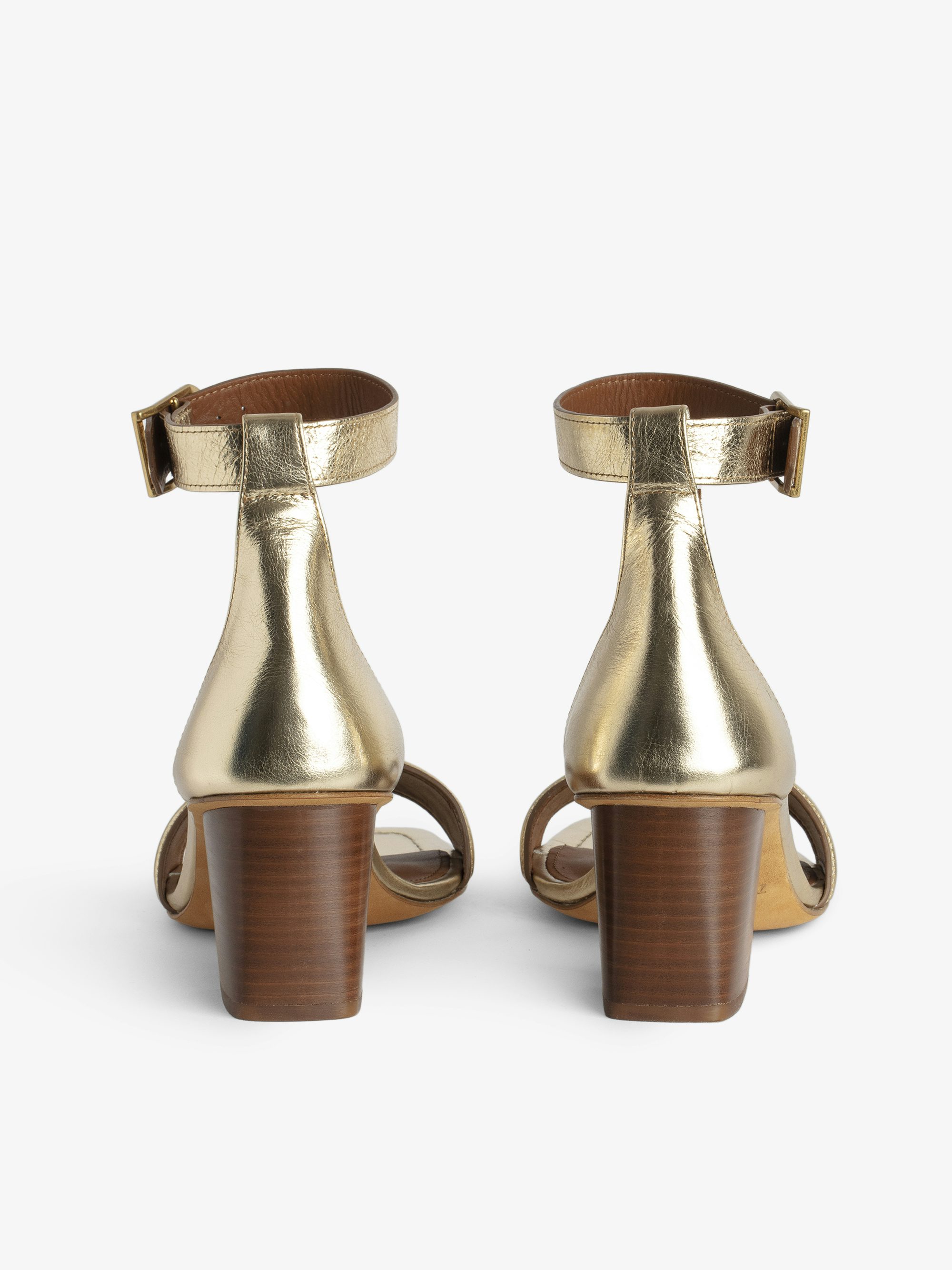 Caprese Sandals - Heeled sandals with leather strap adorned with a wing charm and a signature buckle.